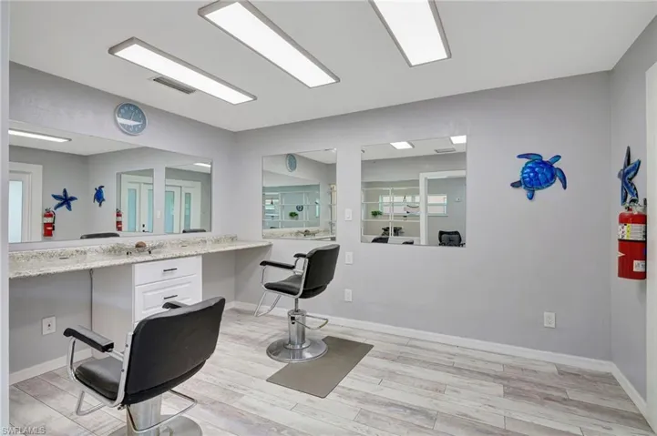 Bathroom featuring vanity, visible vents, baseboards, and wood finished floors