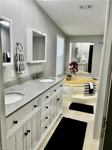 Bathroom featuring double vanity, a bath
