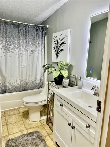 Bathroom with vanity, and shower / tub combo