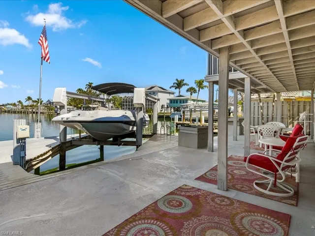 View of patio / terrace featuring a dock and a water view