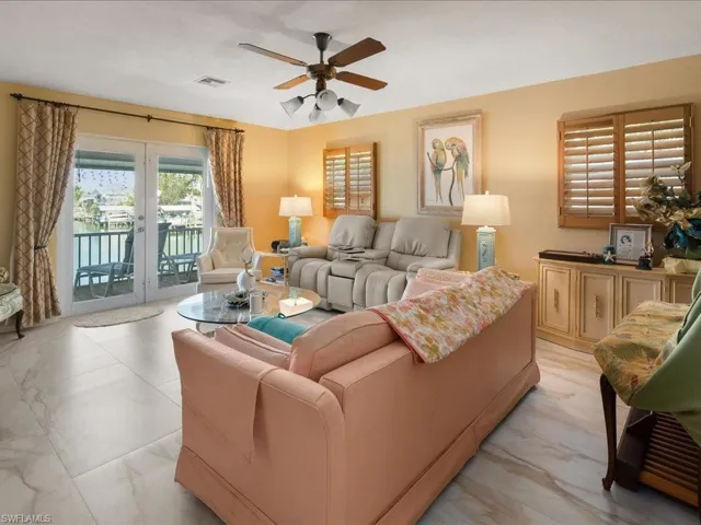Living room featuring french doors and ceiling fan