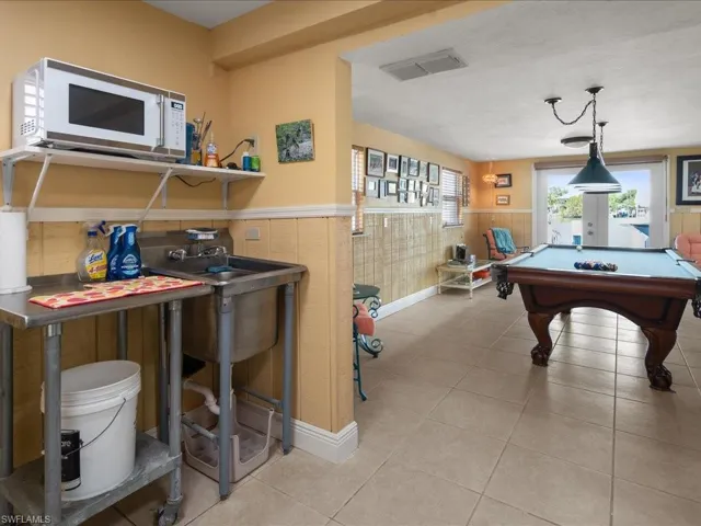 Game room with billiards and light tile patterned flooring