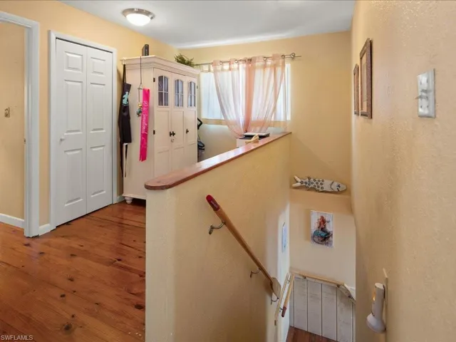 Staircase featuring hardwood / wood-style flooring