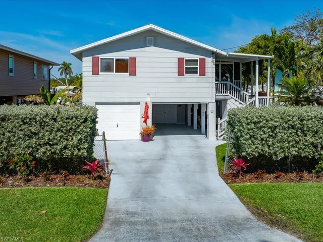 View of front of house with a porch and a garage
