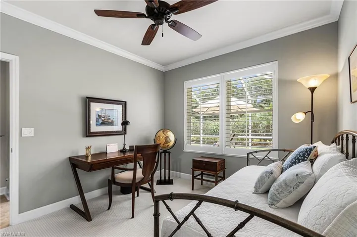 Bedroom featuring crown molding, ceiling fan, and light colored carpet