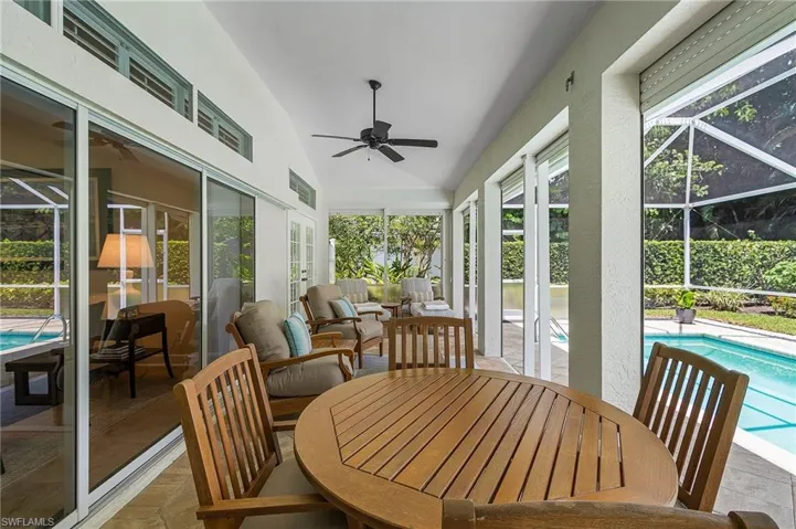 Sunroom featuring vaulted ceiling, outdoor dining area, a patio area, a ceiling fan, and plenty of natural light