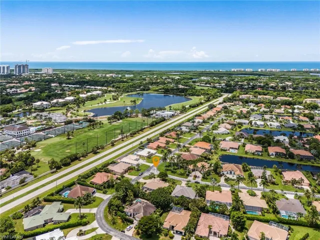 Aerial perspective of suburban area featuring a large body of water