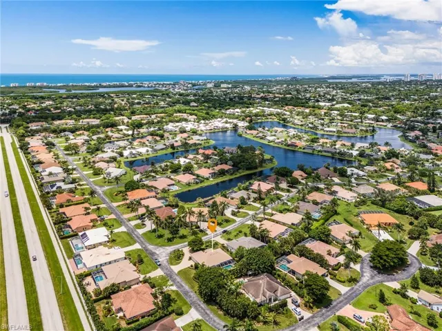 Aerial view of residential area featuring a nearby body of water