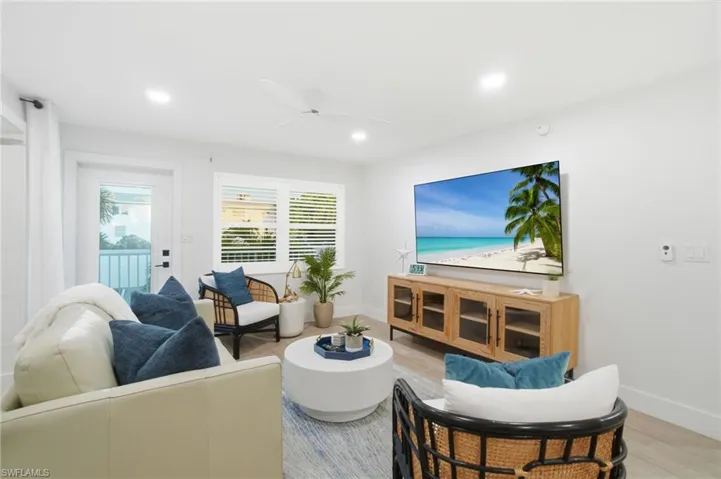 Living room featuring light hardwood / wood-style tile flooring, additional indoor space off of the main living area.
