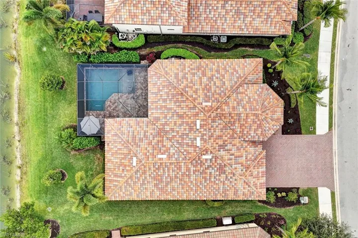 Aerial view of property and surrounding area featuring a pool area