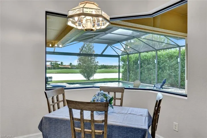 Dining space with a sunroom, a textured wall, and healthy amount of natural light