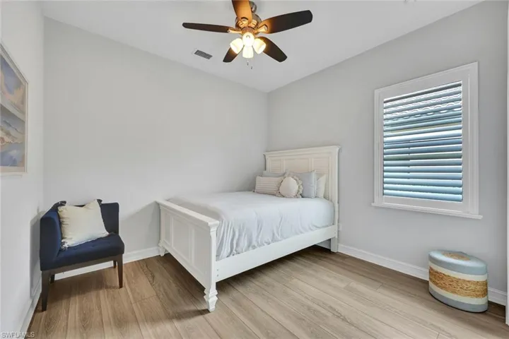 Bedroom with light wood finished floors and ceiling fan