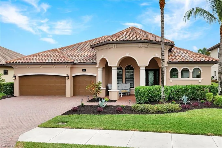 Mediterranean / spanish-style home featuring stucco siding, decorative driveway, a tiled roof, and a garage