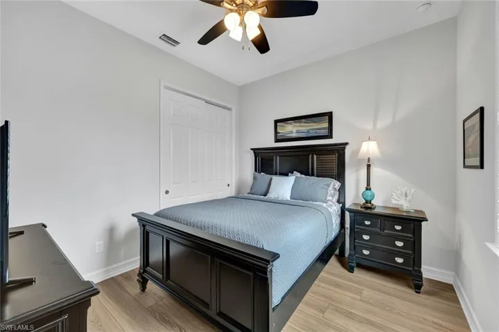 Bedroom featuring light wood-style flooring, a closet, and ceiling fan