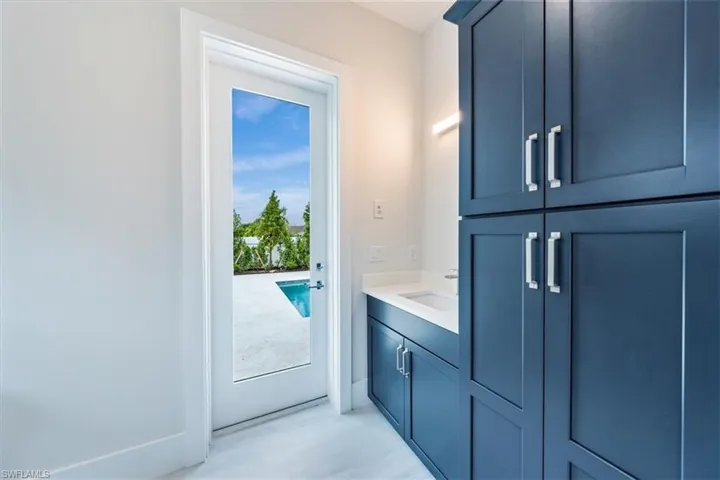 The Bedroom 3 suite features a large walk-in closet and direct access to bathroom 3, which leads out to the pool deck.