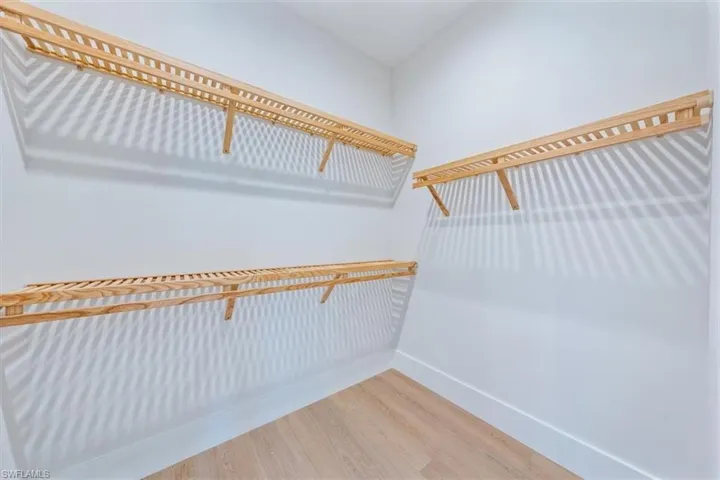 The Bedroom 3 suite features a large walk-in closet and direct access to bathroom 3, which leads out to the pool deck.