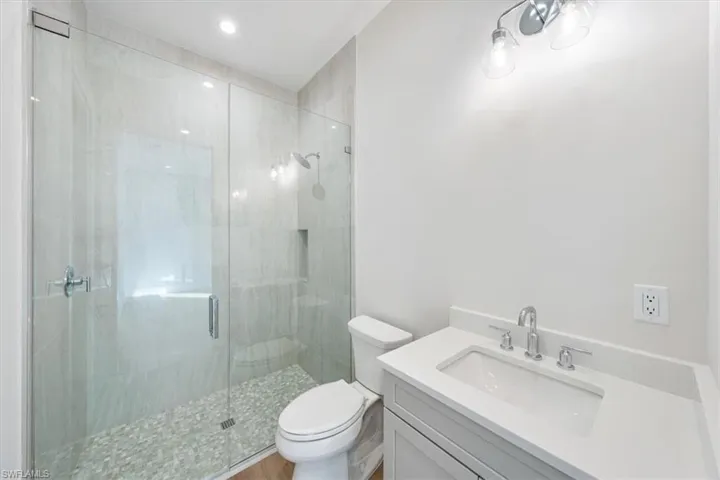 Bathroom 2 features dual entry from the hallway and bedroom 2.