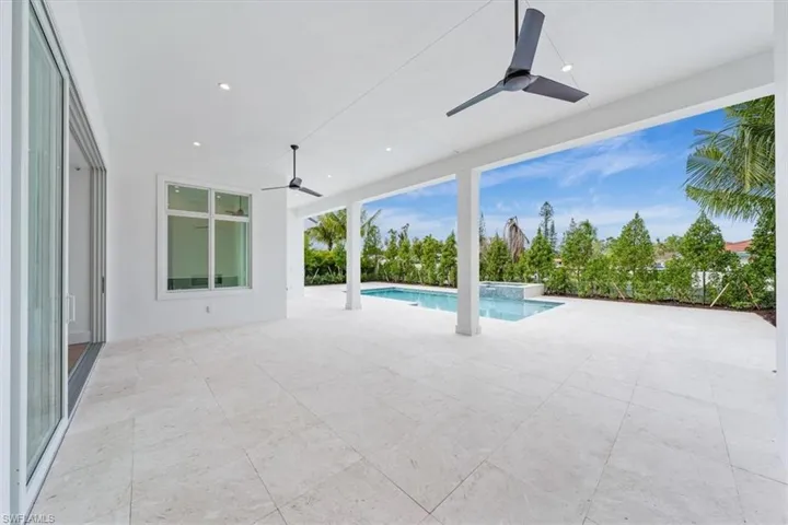 The outdoor living space features both covered and uncovered lounge spaces, a heated saltwater pool and spa, and natural gas fireplace. Soon to be added: An outdoor kitchen and motorized roll-down bug and storm screens (included in the purchase price).