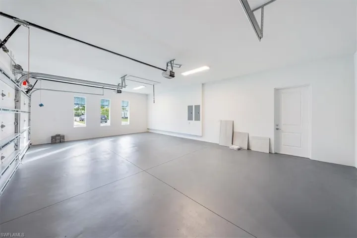 The full 3-car garage features epoxy painted floor treatment and spray foam Icynene insulation above.