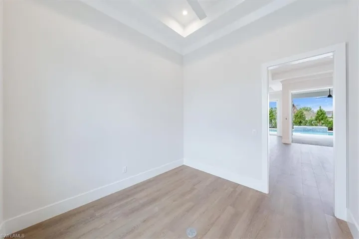 The office is located just off of the great room and features a large picture window, transom, and barn door entry.