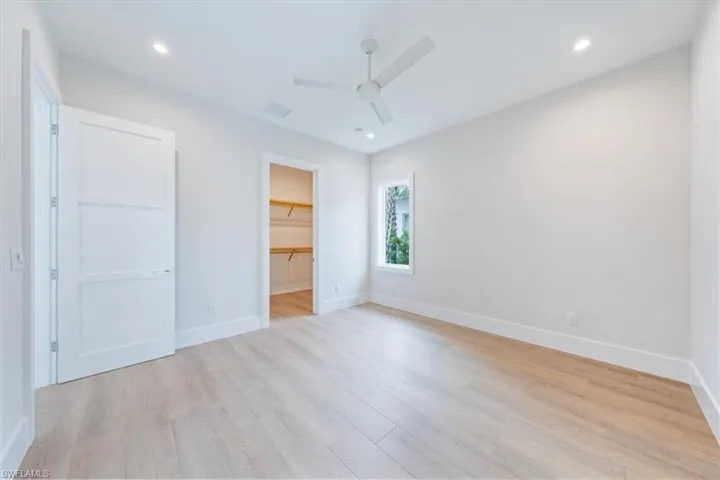 The Bedroom 3 suite features a large walk-in closet and direct access to bathroom 3, which leads out to the pool deck.