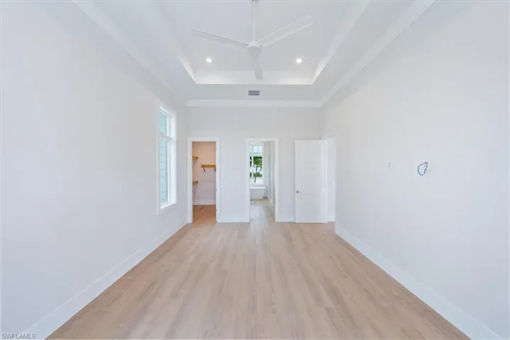 The primary suite features 10' sliders out to the pool deck, dual walk-in closets, and a spa bathroom with shower, free standing soaking tub, private WC, and two sinks.