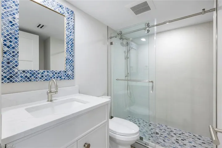 Bathroom with a shower stall and vanity