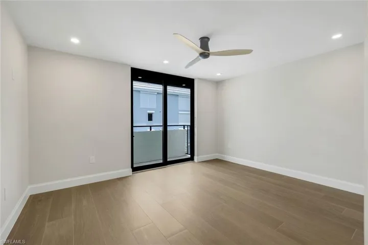 Bedroom featuring wood finished floors, a ceiling fan, and recessed lighting