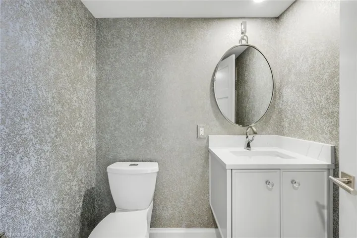 Powder Bathroom with toilet and vanity