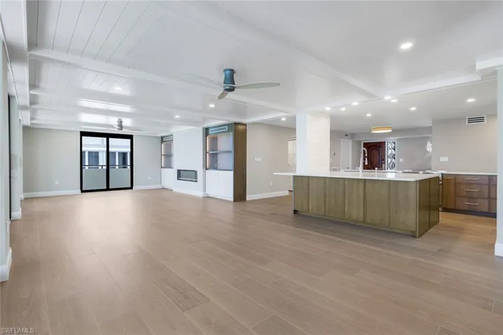 Dinning room featuring beam ceiling, ceiling fan, light wood-type flooring, recessed lighting, and decorative columns