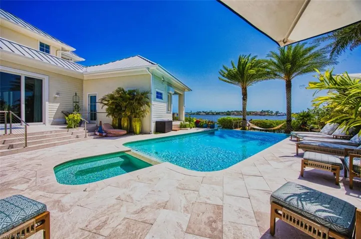 View of swimming pool featuring a patio area and a pool with connected hot tub