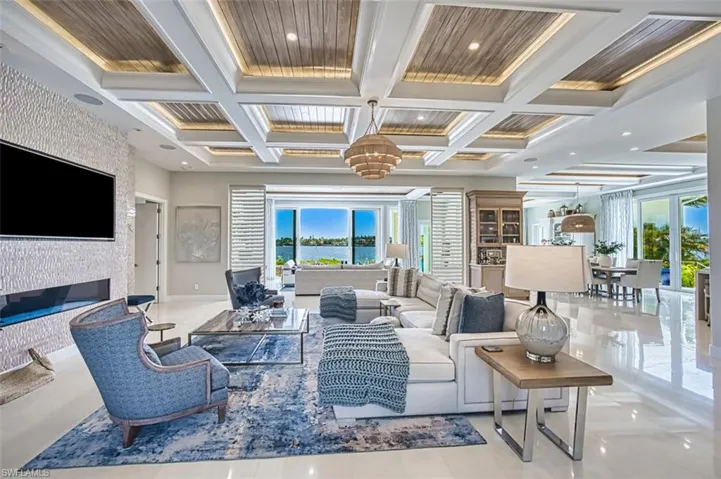 Community lobby featuring coffered ceiling, ornamental molding, beamed ceiling, and recessed lighting
