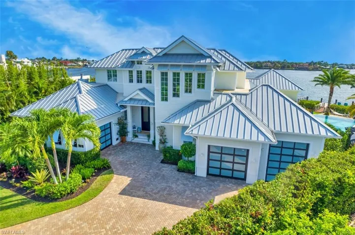 View of front of house with a standing seam roof, a metal roof, and an attached garage