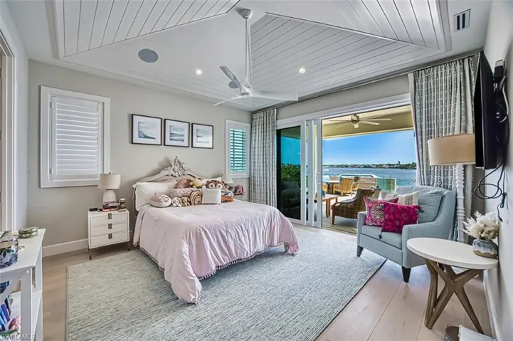 Bedroom featuring access to exterior, wood finished floors, wooden ceiling, and a ceiling fan