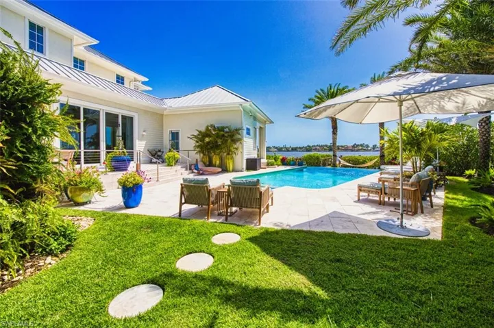 Swimming pool with a patio area and a lawn