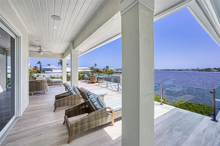 View of patio / terrace with a water view and a ceiling fan