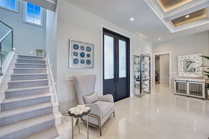 Tiled foyer featuring stairs, plenty of natural light, and recessed lighting