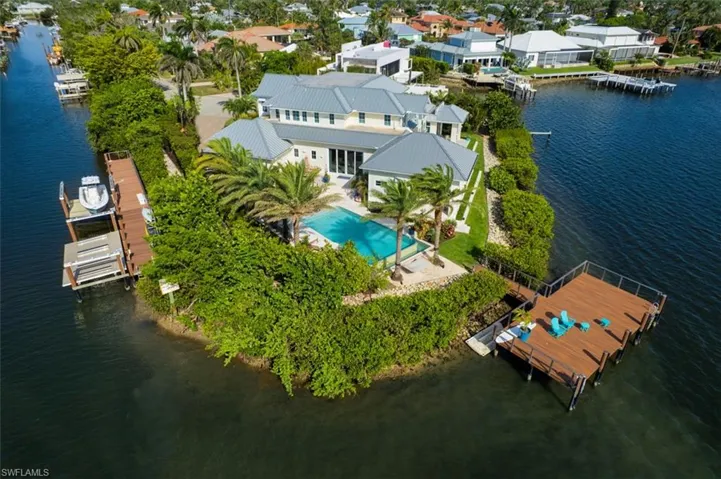 Bird's eye view of a nearby body of water and a pool area