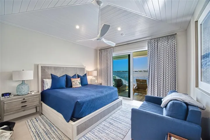 Bedroom featuring access to exterior, wood finished floors, wooden ceiling, a ceiling fan, and ornamental molding