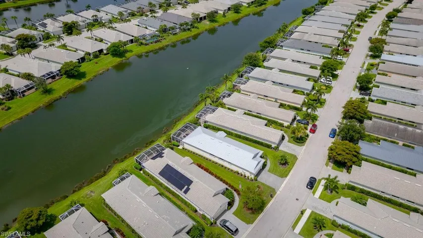 Aerial perspective of suburban area featuring a large body of water