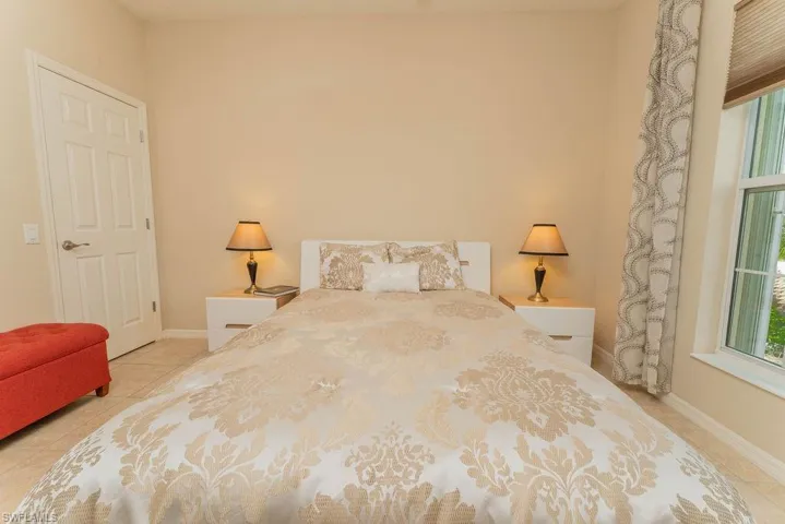 Tiled bedroom featuring baseboards