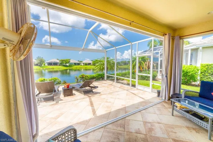 Sunroom / solarium featuring a water view and plenty of natural light