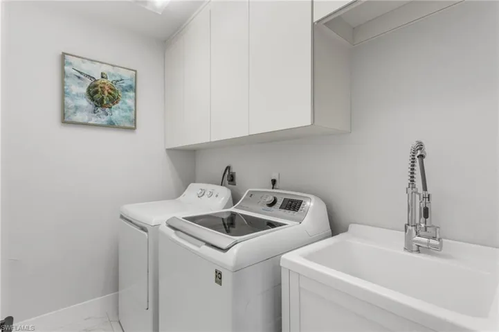 Laundry room with laundry sink and extra storage.