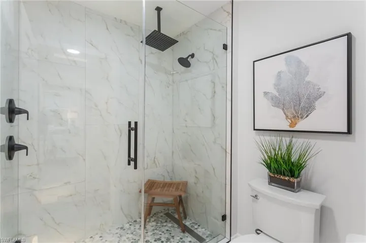 guest bathroom with private shower and commode area.