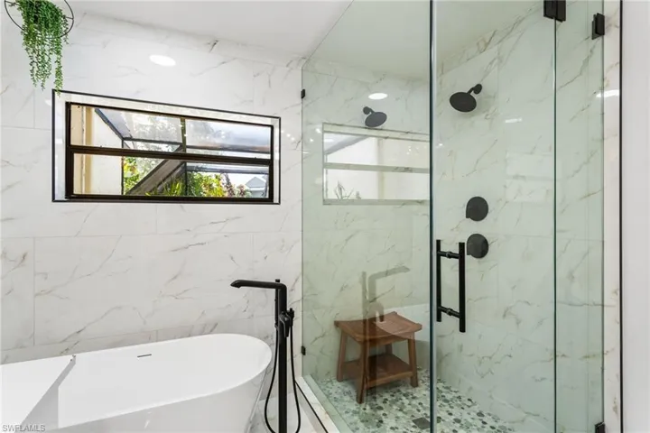 Stand alone tub, multiple shower heads, pebble tile, glass shower doors...beautiful