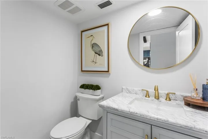 Powder room. Quartz counters, new toilet, vanity, plumbing/electrical fixtures.