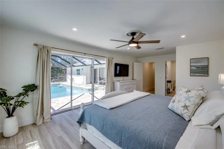 This room features light-colored flooring, a ceiling fan, and recessed lighting