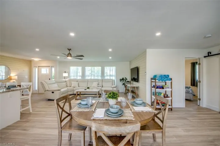 The property features an open-concept living area with light-colored flooring throughout