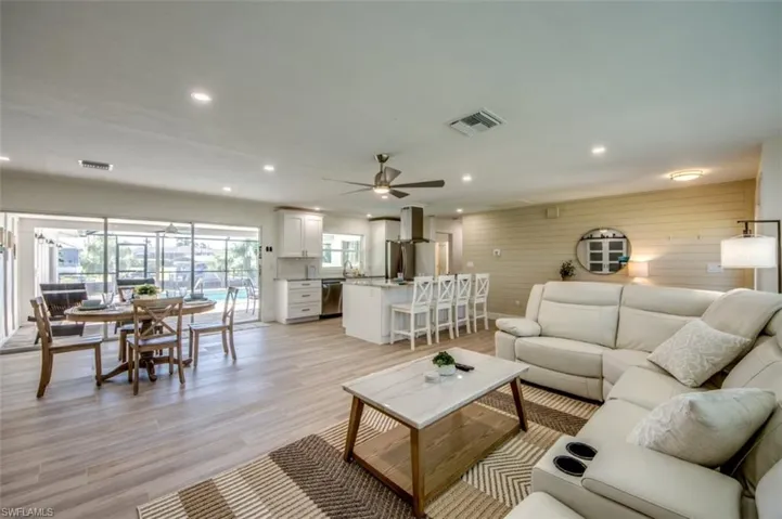 Open concept living area featuring light-toned flooring, recessed lighting, and a ceiling fan