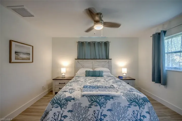 Bedroom featuring light-colored flooring, white walls, and a ceiling fan